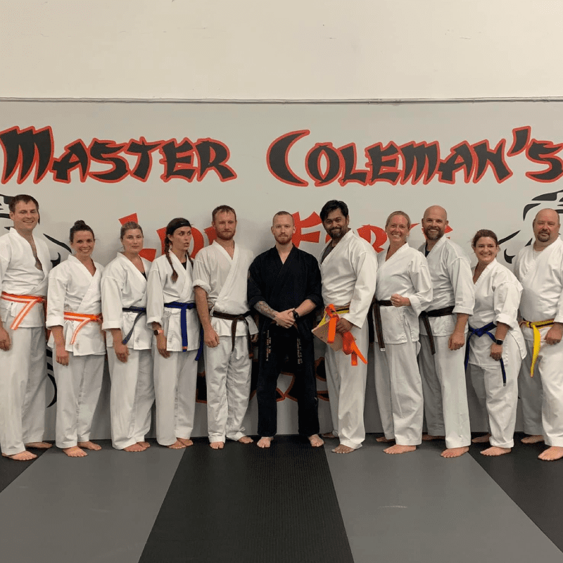 Adults a group of people, possibly martial arts students, posing together for a photo